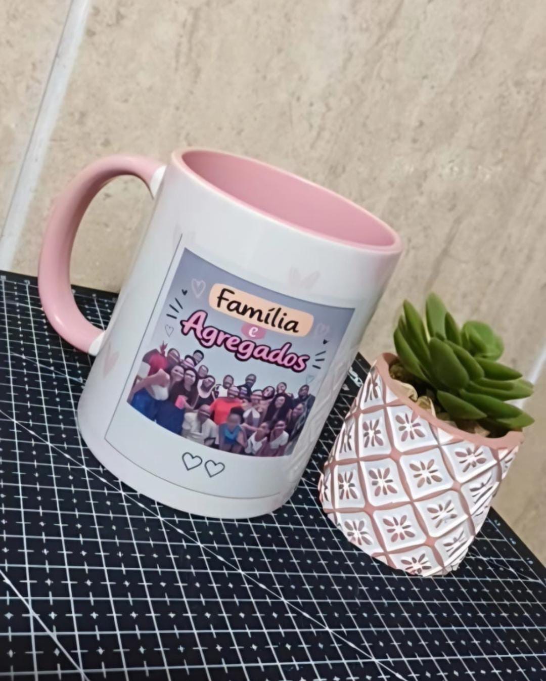 Caneca branca com interior e alça rosa e foto de família em grupo